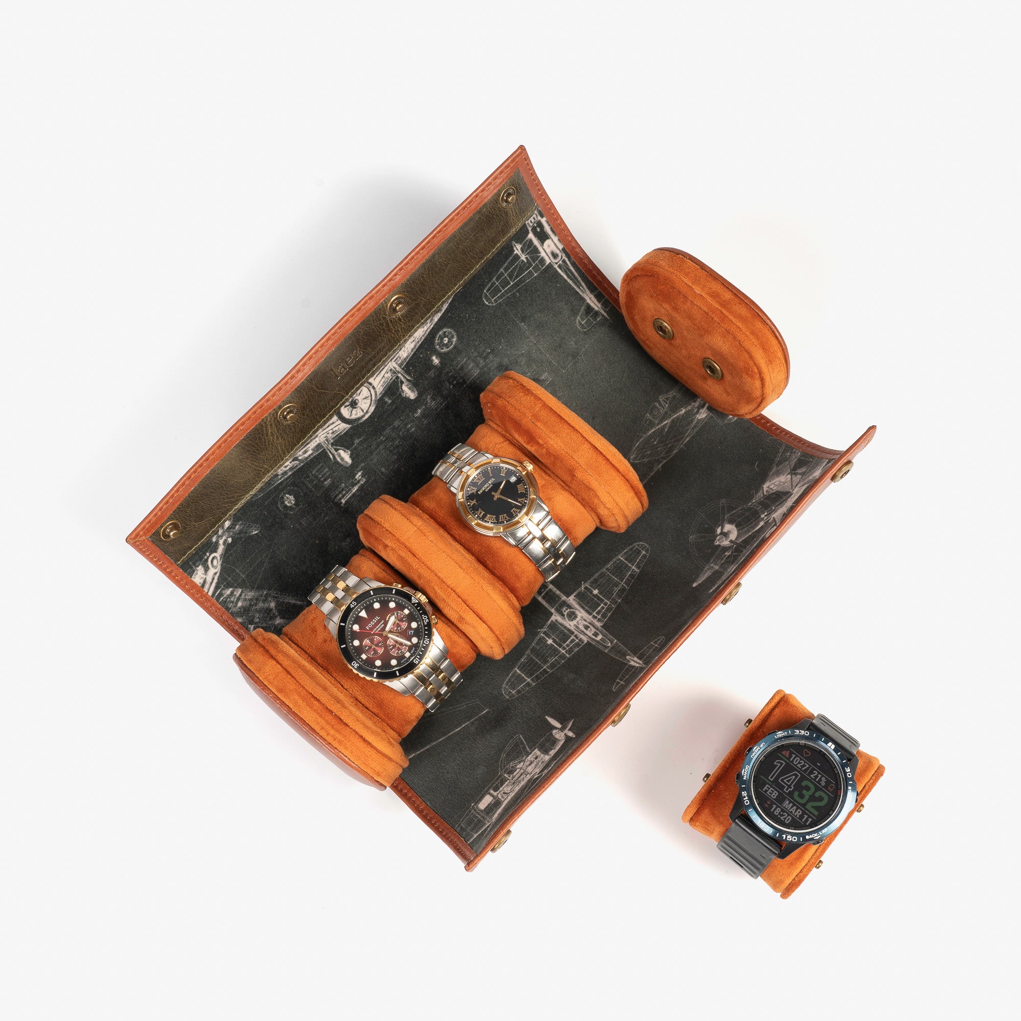 A leather travel watch roll displaying three elegant watches within a stylish case.