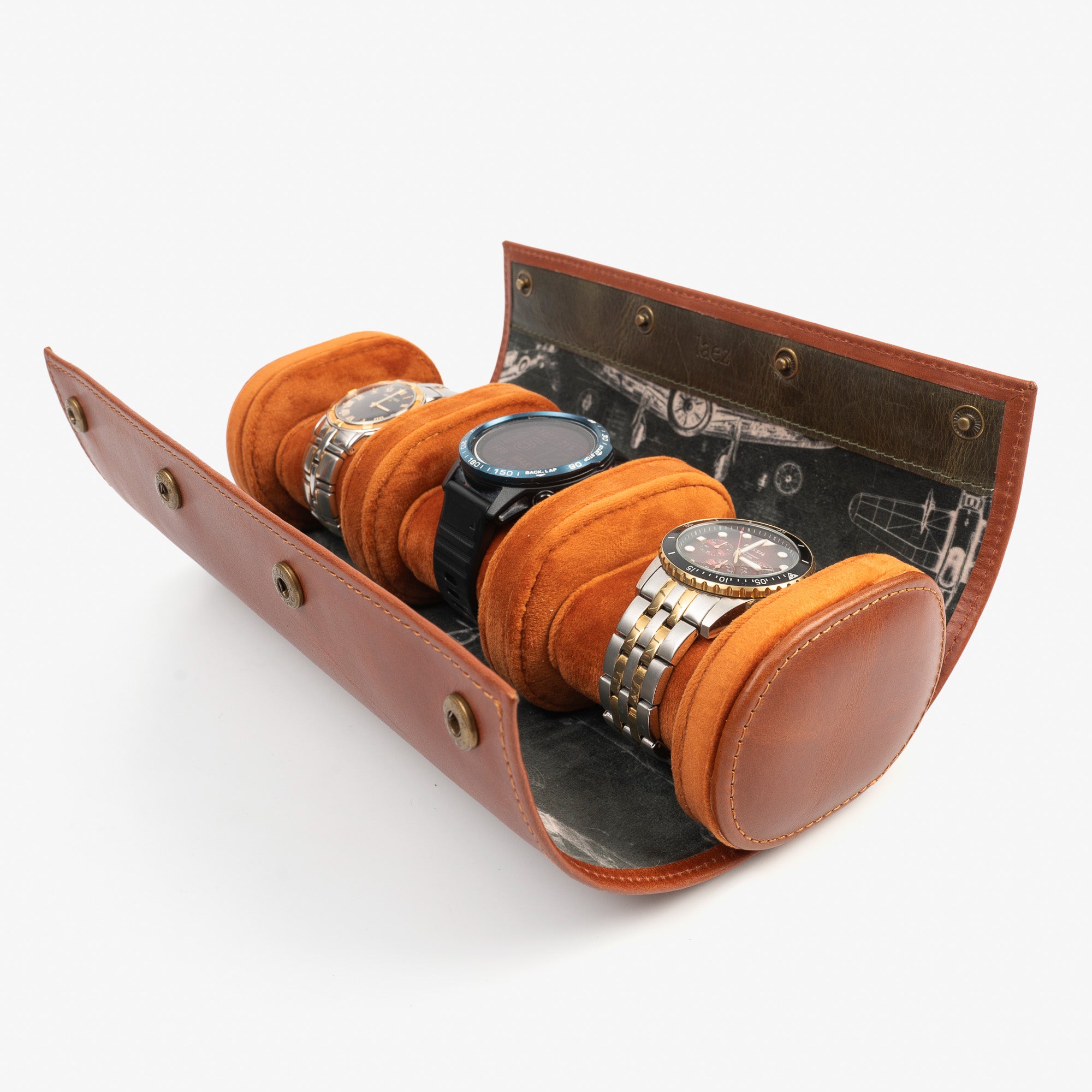A leather travel watch roll displaying three elegant watches within a stylish case.
