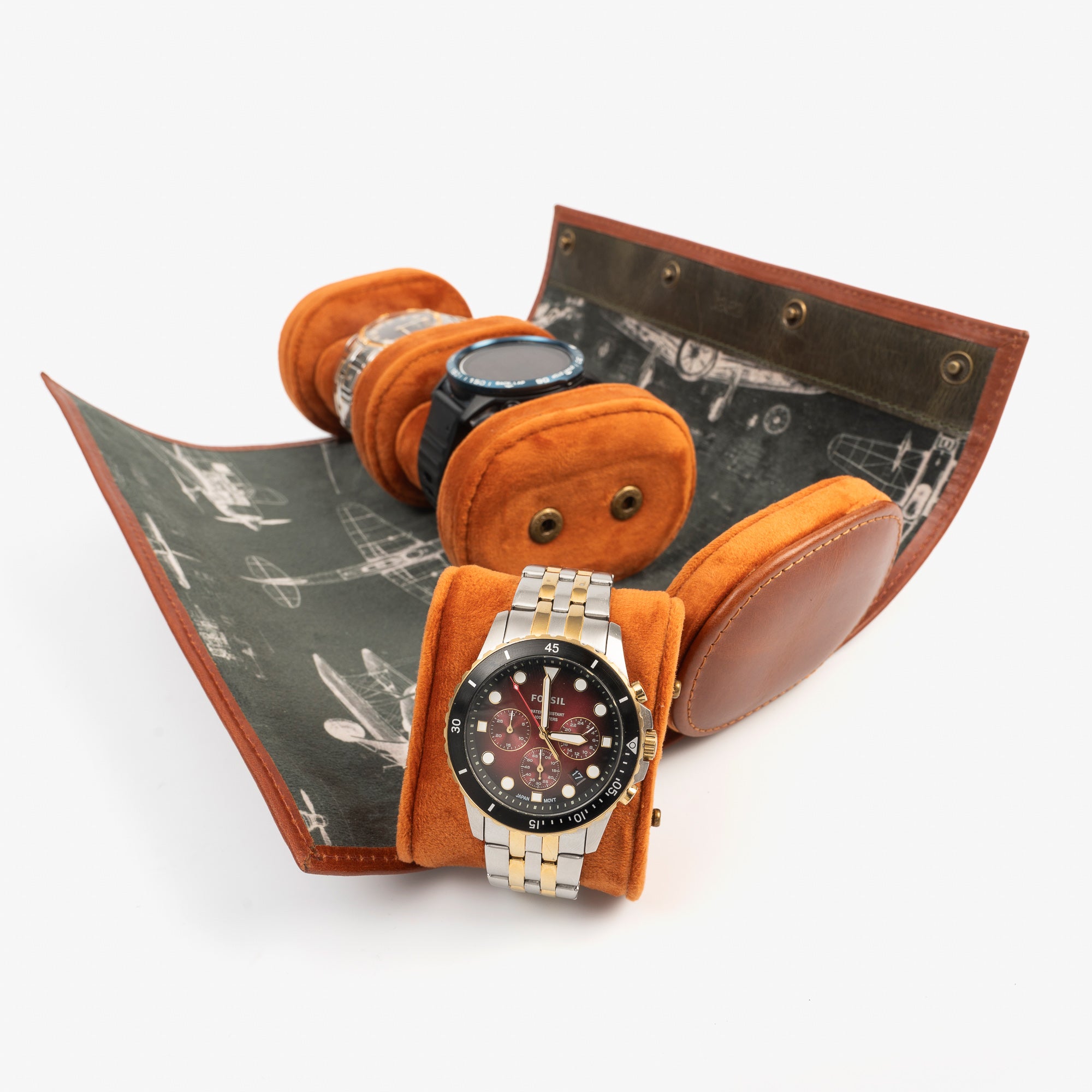A leather travel watch roll displaying three elegant watches within a stylish case.