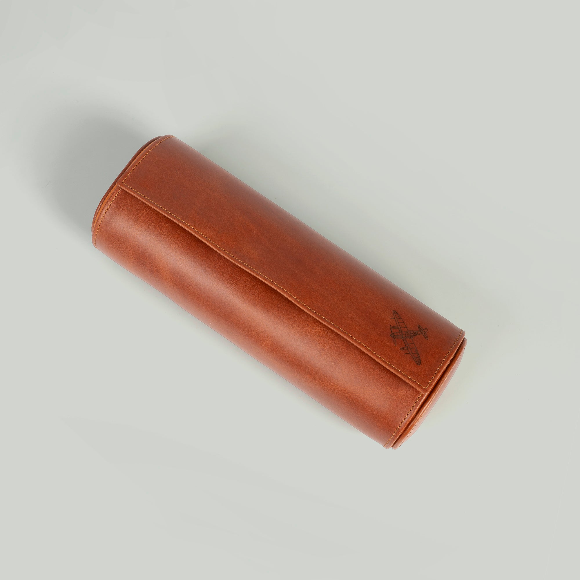 A leather travel watch roll displaying three elegant watches within a stylish case.