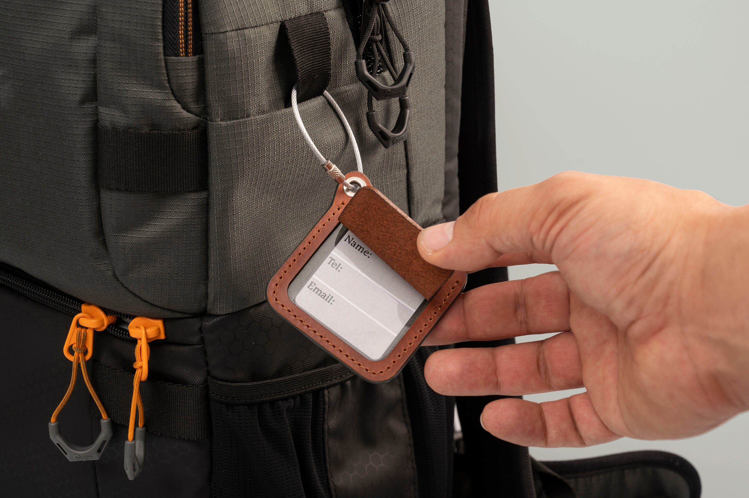 Leather luggage tags with metal rings, elegantly designed for travel organization and personalization.